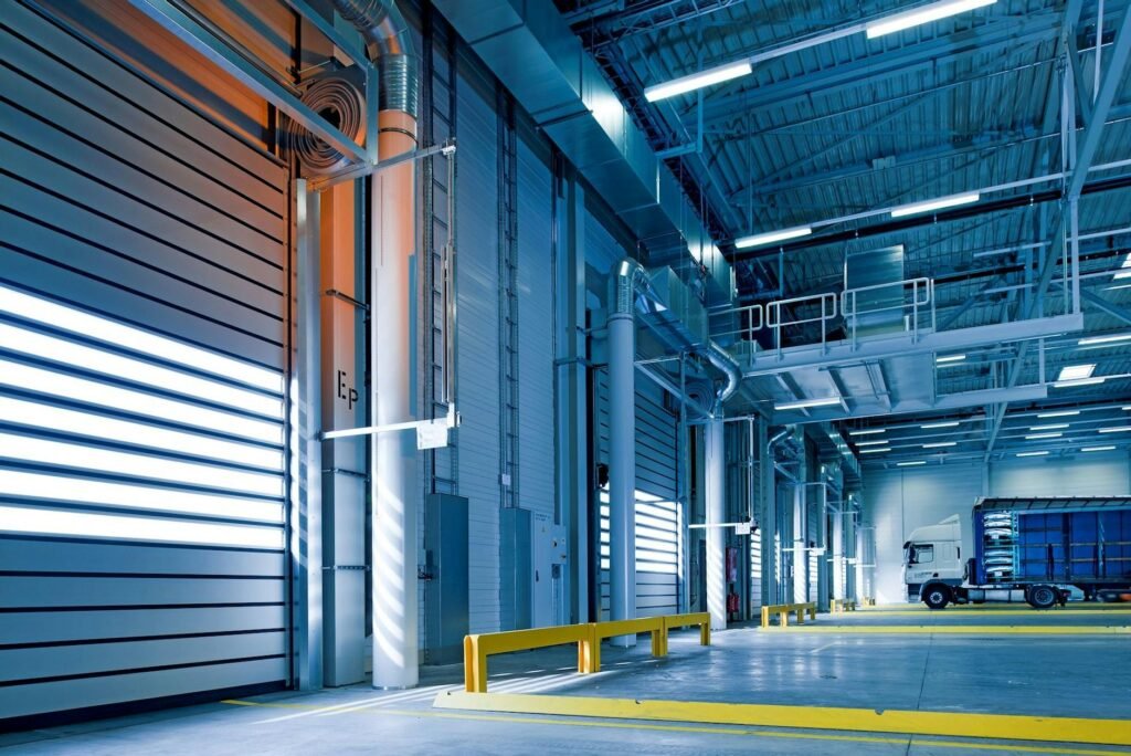 pexels-photo-209251-209251 Spacious and modern warehouse interior with parked truck and steel structures.